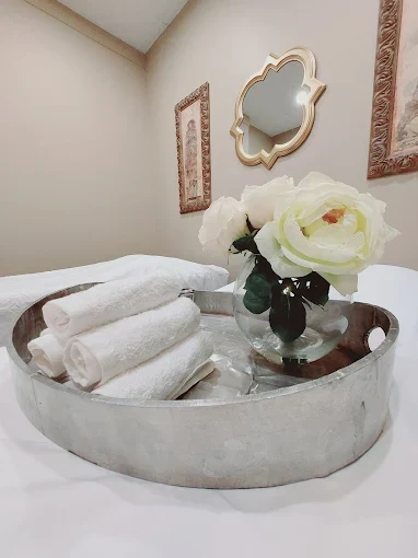 Towels and flowers ready in a treatment room